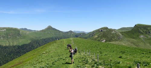 Scenic hike on the green ridges with Puy Mary in the background