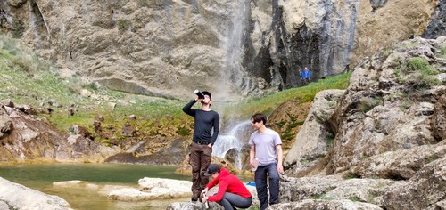 Refilling the water bottlels with fresh water from the waterfall