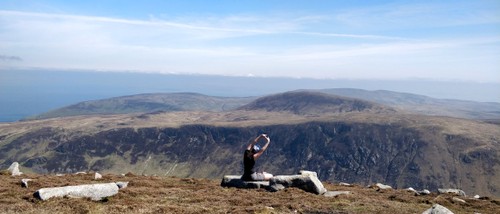 Stretching on top of the mountain after a strenous ascent